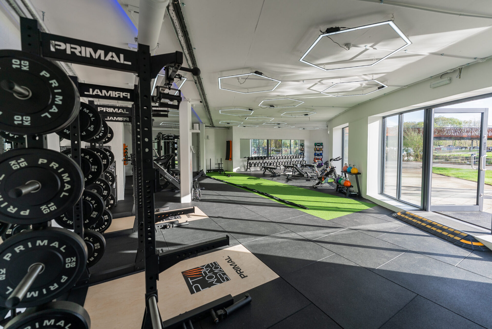 Personal trainers working with clients in a modern gym facility available for hire in London, Harrow, and Milton Keynes