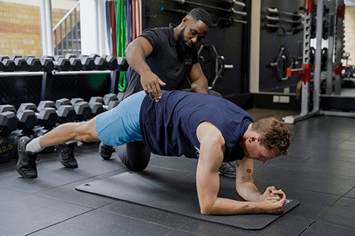 Male Client and Personal Training showing Correct Technique in Plank